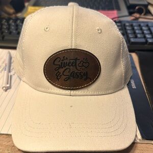 White mesh ball cap with custom leather patch that says sweet & Sassy